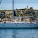 A sailboat with 5 passengers anchored near the coastline of Cagliari